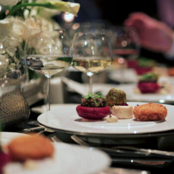 Elegant Fine Dining Experience at a Luxury Event. A beautifully plated dinner set on a luxurious table.